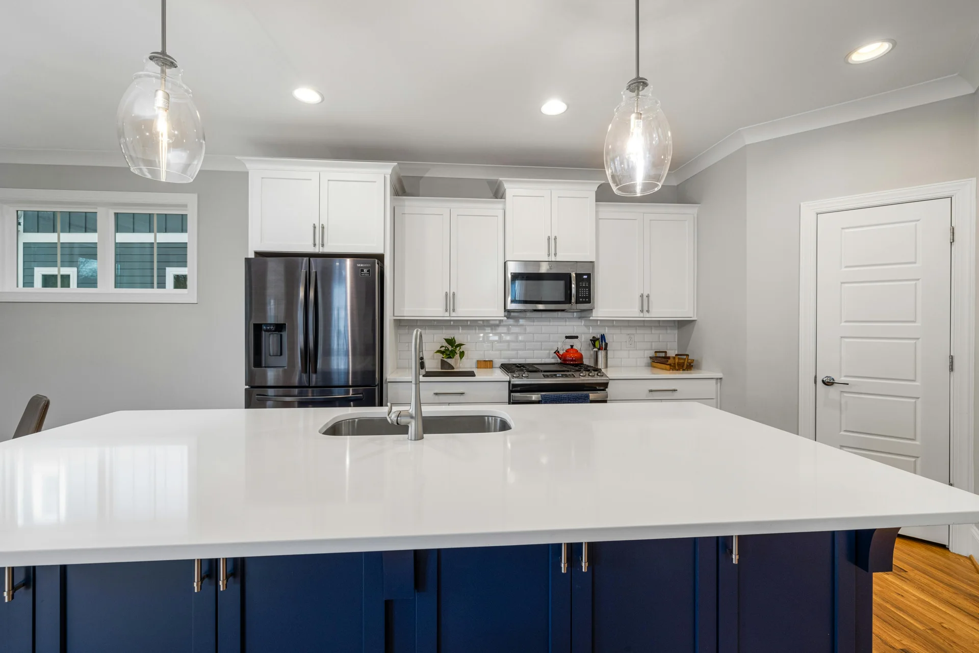 Bright kitchen with white counters and cabinetry