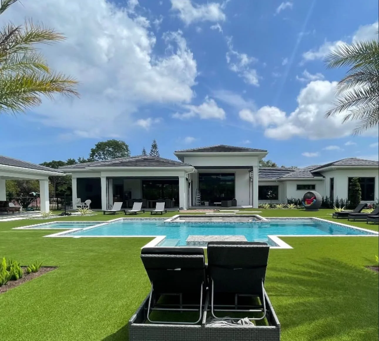 Pool, sun shelf, lawn, and modern home from the Moncada project gallery